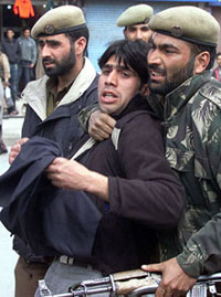Policemen detain a Shia Muslim mourner during a tazia procession in Srinagar on Sunday.