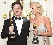 Actor Sean Penn and actress Charlize Theron hold their Oscar statues for the Best Actor and Best Actress awards, respectively, at the 76th annual Academy Awards