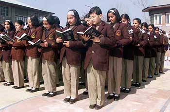 Schoolgirls read morning prayers after winter vacations in Srinagar