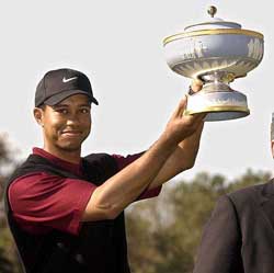 Tiger Woods holds up the trophy after his victory at the World Golf Championships Accenture Match Play Championship in Carlsbad, Calif