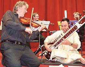 A French artiste matches tunes with a sitarist during a concert of western classical music by Les Solistes Fracaise at the CSIO auditorium in Sector 30, Chandigarh