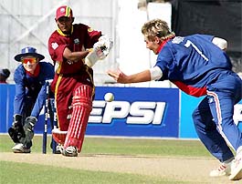 English bowler Luke Wright tries to stop a drive by West Indies batsman Denesh Ramdin on during their semifinal match at the ICC U-19 World Cup in Dhaka 
