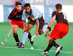 India�s Kamaldeep Singh controls the ball while Belgium�s Dennis Dijkhoorn and Charles Vandeweghe try to stop him