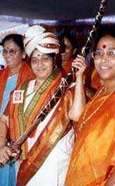 Union Health Minister Sushma Swaraj holds a sword presented to her by the state BJP women's wing