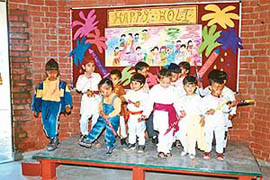 Children of Rai School, Sector 48, celebrate Holi on the school premises in Chandigarh on Friday.