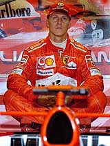Germany's world champion Ferrari's Michael Schumacher sits in his team garage during the first practice session