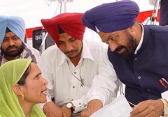 Lok Bhalai Party chief Balwant Singh Ramoowalia listens to grievances of a victim of an NRI bridegroom