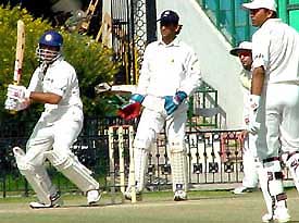 Yuvraj Singh plays a shot towards deep mid-wicket as Akash Chopra looks on 