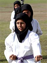 Afghan female athletes perform martial arts during a demonstration to mark International Women's Day in Kabul