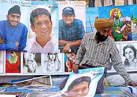 A vendor sells posters of cricketers in Amritsar