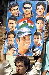 A fan holds a collage featuring Indian cricket players