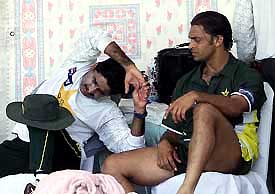 Pakistan's fast bowler Shoaib Akhtar and coach Javed Miandad take a break during a practice session at National Stadium in Karachi