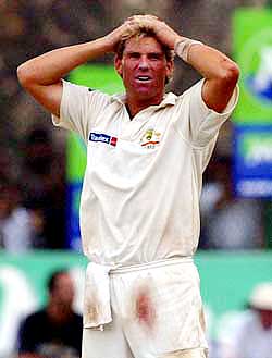 Australia's Shane Warne reacts after being hit for a boundary by Sri Lana's Tillakaratne Dilshan 