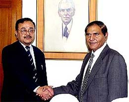 Joint secretary of Pakistan's Ministry of Communication Mustaq Mohammad Khan greets his Indian counterpart Alok Rawet in Islamabad