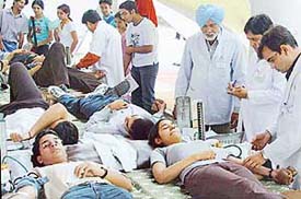 Students donate blood at a blood donation camp organised at the Administration Block of Panjab University in Chandigarh on Wednesday.