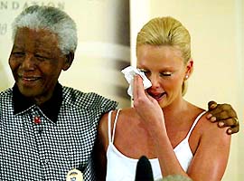 Oscar winning South African actress Charlize Theron weeps at her meeting with former South African President Nelson Mandela 