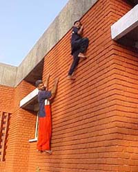 Renu Kumari climbs a wall with her father, Gurbachan Singh, at the Kapurthala Police Lines