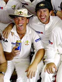 Australia's Shane Warne celebrates with captain Ricky Ponting after they won the first Test in Galle