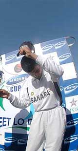 Indian cricket captain Saurav Ganguly takes off his cap on a request by photographers during a photo-session at the National Stadium