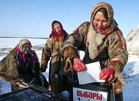 A Nenets woman drops her ballot