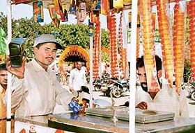 An ice-cream vendor at the Spring Fest in Panchkula is hooked to the transistor as India and Pakistan clash in a cricket match in Karachi