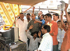 Cricket buffs enjoy the telecast of the ODI in a makeshift structure in Paharganj in the Capital on Saturday.
