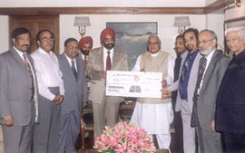 Prime Minister Atal Behari Vajpayee receiving a cheque of Rs 2 crore from S. S. Kohli, CMD of Punjab National Bank, for the Prime Minister�s Relief Fund. Other senior officials of the bank are also seen in the picture.