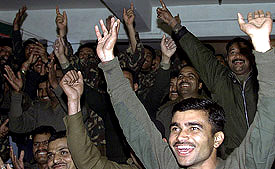 Border Security Force personnel celebrate India's five run victory over Pakistan in the first one-day cricket match, in Srinagar