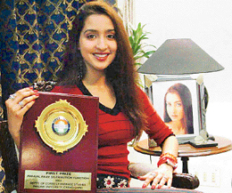 Ambika Dhinsa with the trophy she won for securing the first position in the MFC course of Panjab University at her house in Sector 9, Panchkula, on Sunday.