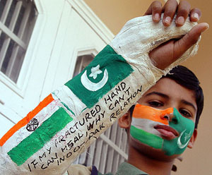 A young cricket fan displays his ingenuity by using the plaster on his fractured arm to appeal for better Indo-Pak relations, in Ambala on Saturday.