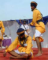 Sikh youths in traditional attire display martial art at Khalsa Heritage Gatka Competition in Amritsar