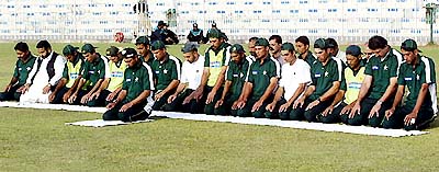 Pakistani cricketers offer prayers during a training session in Rawalpindi