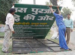Workers removing a hoarding of chief Minister Mr Om Prakash Chautala in Ambala City on Monday. 