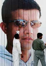 Workers give final touches to the side screen