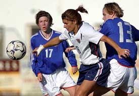 Mia Hamm of the US ights for the ball with France's Sandrine Dusang and Elise Bussaglia 
