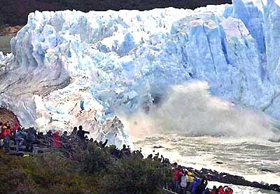Tourists watch as the front wall of the Perito Moreno glacier, measuring 70 metres, breaks down at Lago Argentina