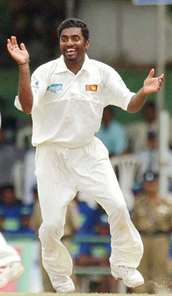 Sri Lankan offie Muttiah Muralitharan celebrates as he takes his 500th Test wicket