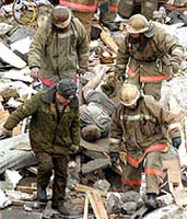 Russian emergency workers carry a rescued man away from the blast site in Arkhangelsk 