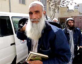 A former Afghan prisoner holds a copy of the Koran at the ICRC compound in Kabul