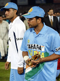 Sachin Tendulkar holds his Man of the Match trophy next to captain Sourav Ganguly in Pindi Stadium, Rawalpindi 