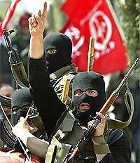 Palestinian gunmen hold AK-47 rifles during the funeral of two Palestinians killed in Gaza city 