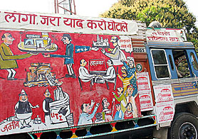 A truck carrying cartoons  depicting the financial scams of the country moves on the Meerut road