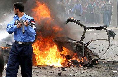 An Iraqi policeman guards the area after a bomb exploded outside Basra's Mirbad hotel on Thursday