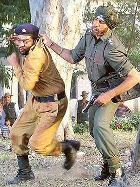 Amitabh Bachchan captures Ashutosh Rana (playing a Pakistani general) in a fight sequence during the shooting of Anil Sharma's film "Ab Tumhare Hawale Watan Saathiyon" at Chandi Mandir on Friday. 