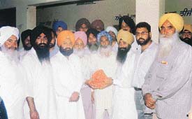 SAD-BJP candidate Sharanjit Singh Dhillon receives a purse containing Rs 1 lakh 