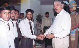 Mr J. K. Sinha, DG, CRPF, giving away gifts to Jammu students who are on an educational tour to Delhi. The tour was organised by the CRPF as part of a civic action programme at the CRPF HQs recently.