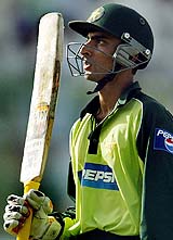 Yasir Hameed raises his bat to acknowledge the cheering crowd, as he walks back to the pavillion after scoring 98 runs in the third one-day international