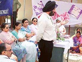 Generating awareness: Maloya village residents being told about their rights and other issues during a camp held in Chandigarh on Saturday.