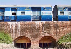 A train passes over a railway bridge supported by wooden beams near the Kesari railway station on the Ambala-Saharanpur main line