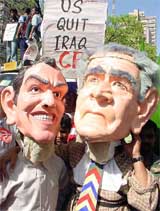 Activists of different leftist parties wear masks depicting US President George Bush and British Prime Minister Tony Blair at a protest rally